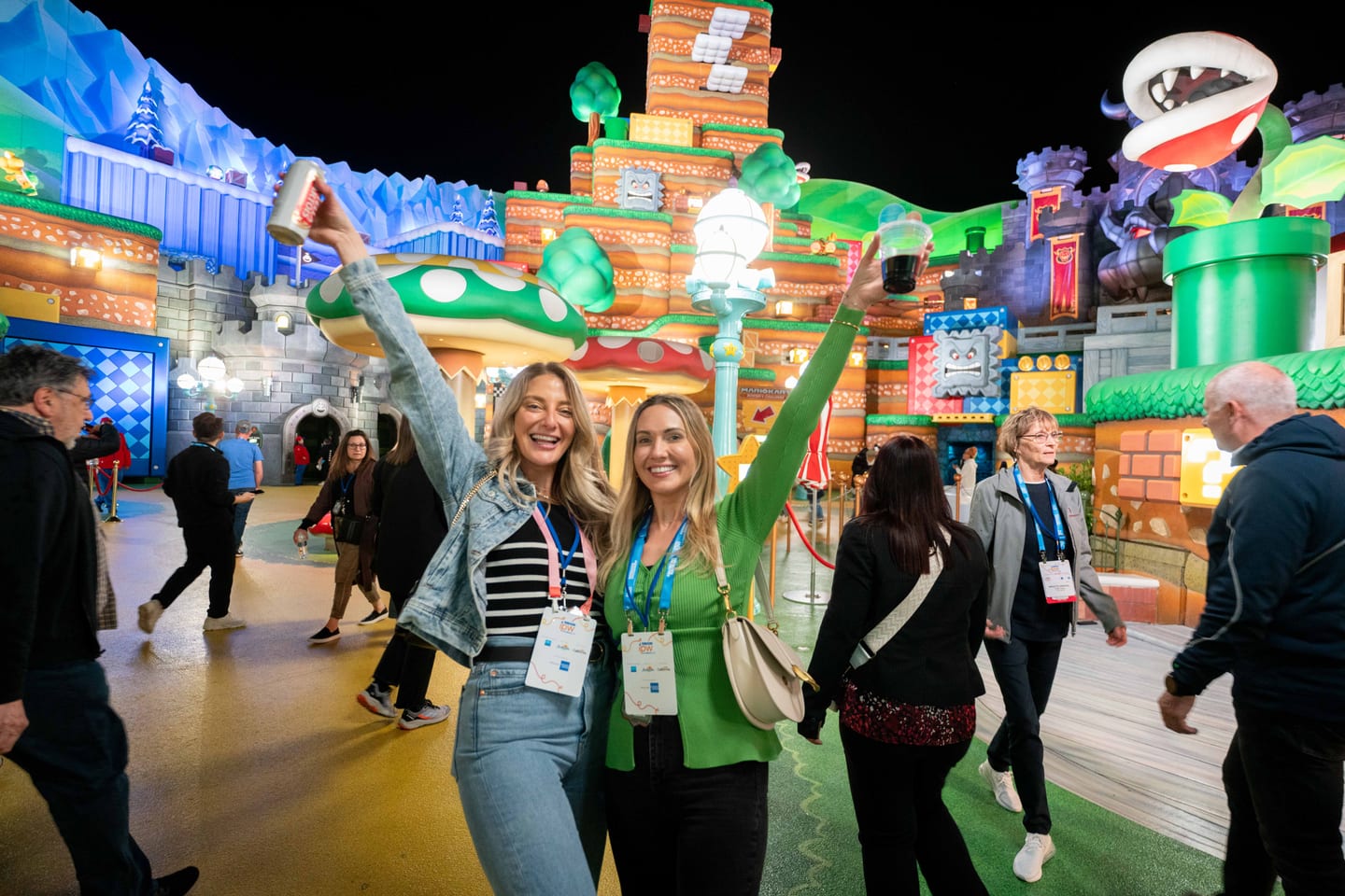 Two delegates taking a selfie in the Super Nintendo World area at the IPW closing party