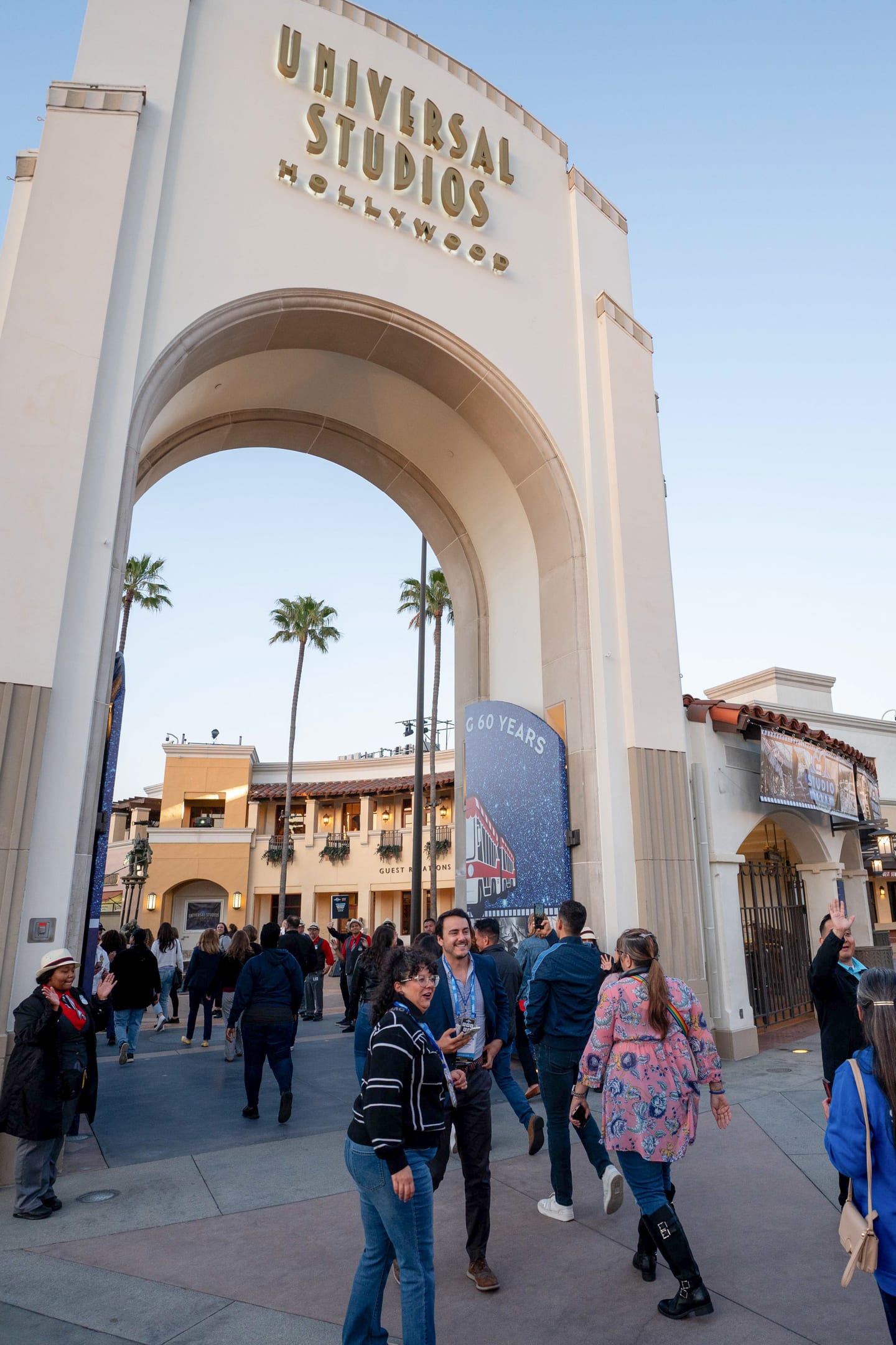 IPW delegates walking under the Universal Studios Hollywood entrance arch at the closing party
