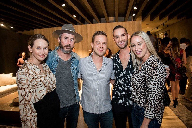 Five well-dressed guests together at the Melteni event in Beverly Hills