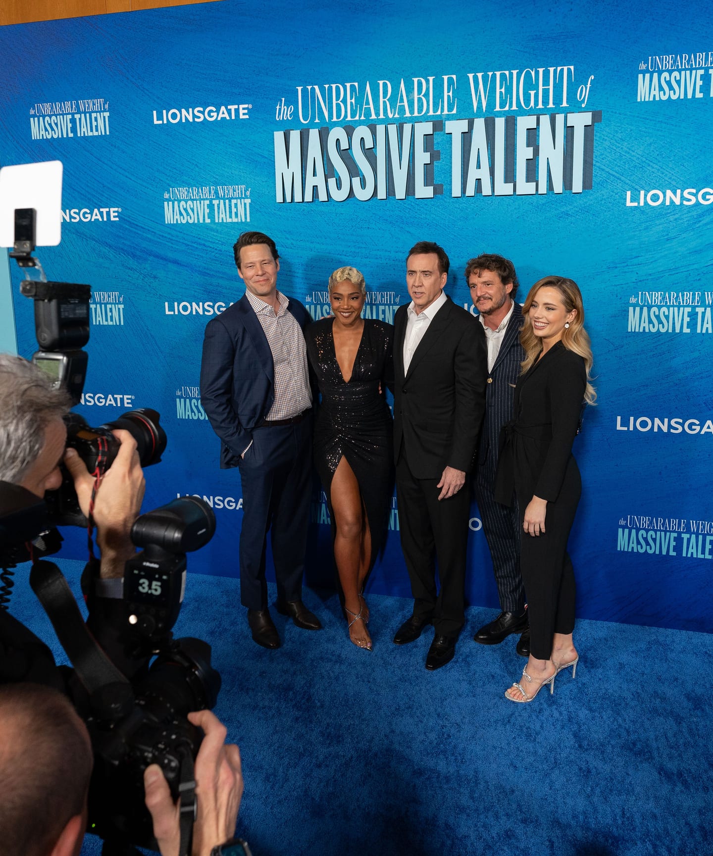 Cast of The Unbearable Weight of Massive Talent, including Nicolas Cage and Pedro Pascal, on the blue carpet at the Lionsgate premiere