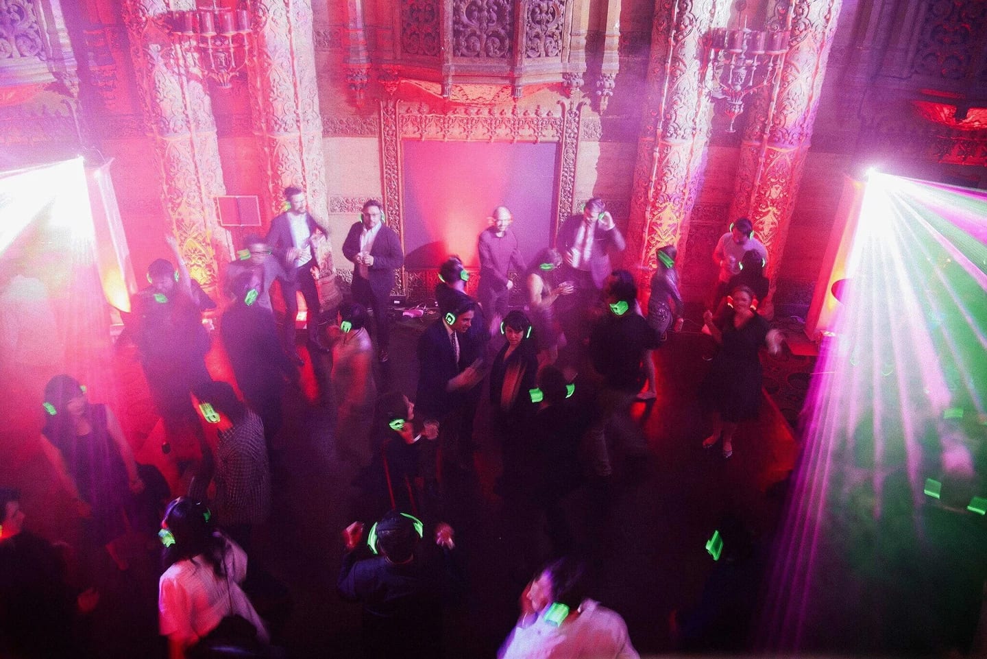 Guests dancing under red light at a silent disco in a Downtown Los Angeles venue