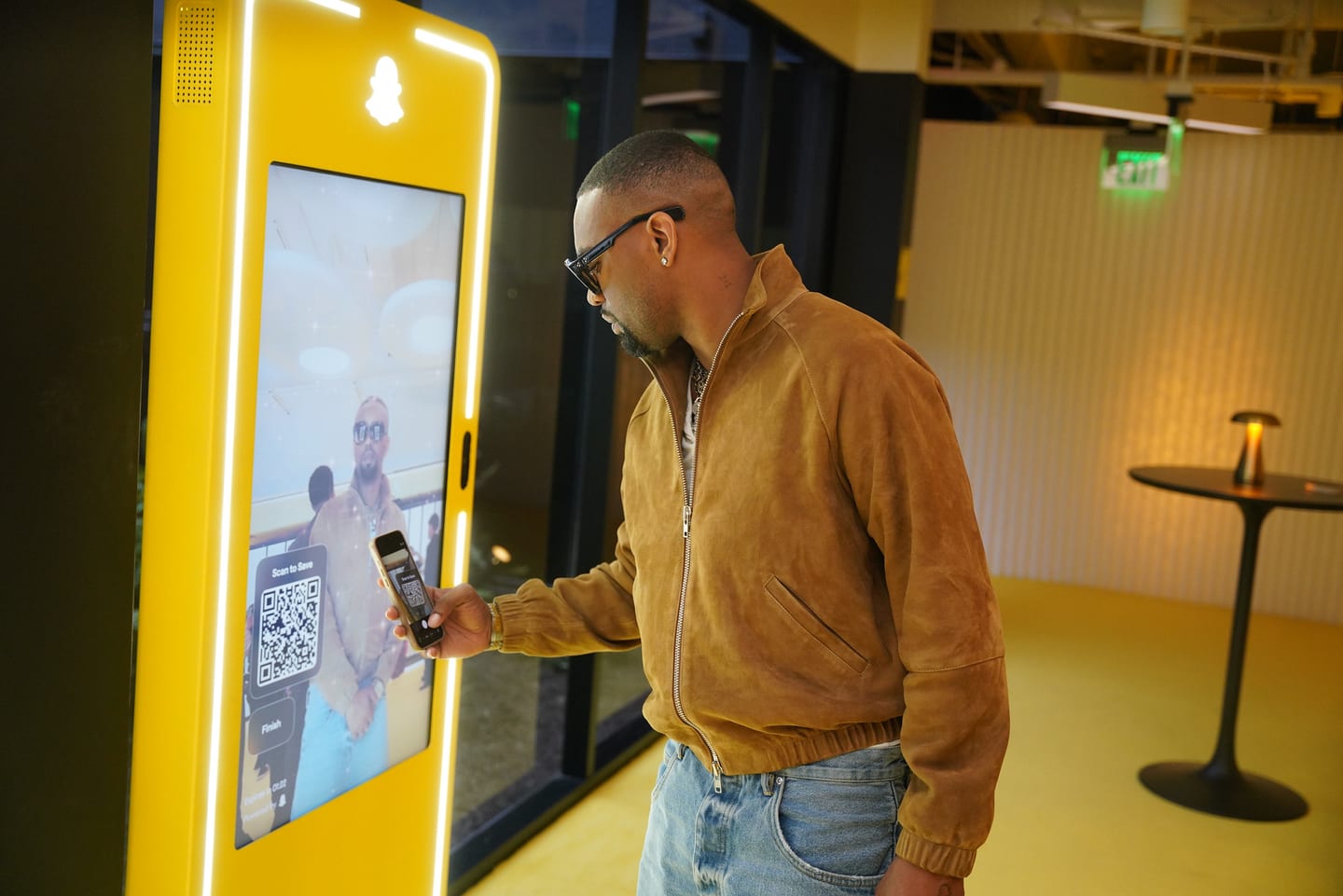 A guest using a yellow interactive kiosk screen