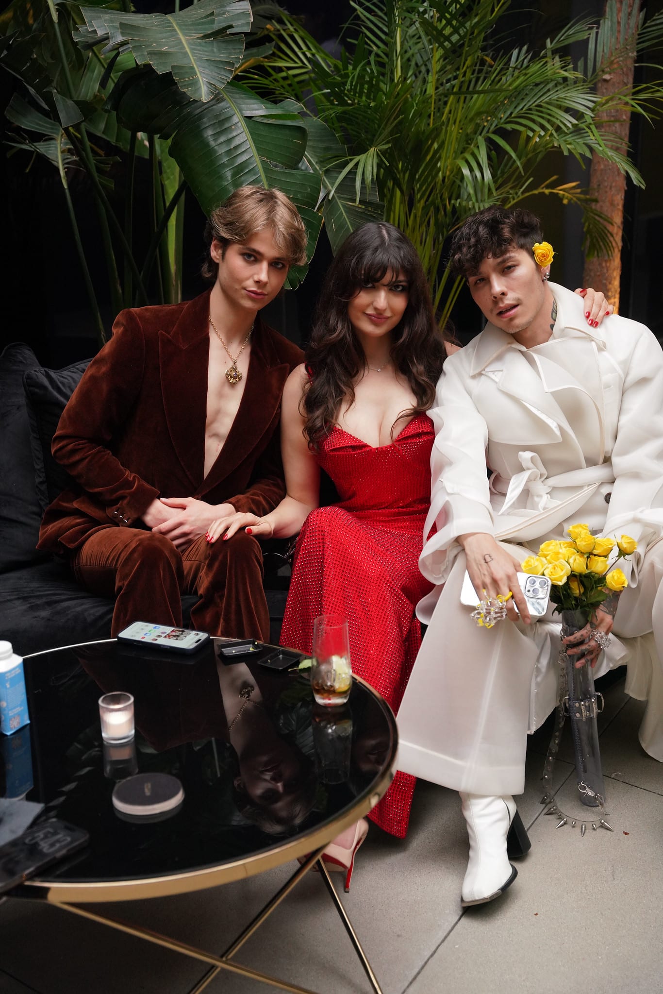 Three guests seated at a lounge table with yellow flowers
