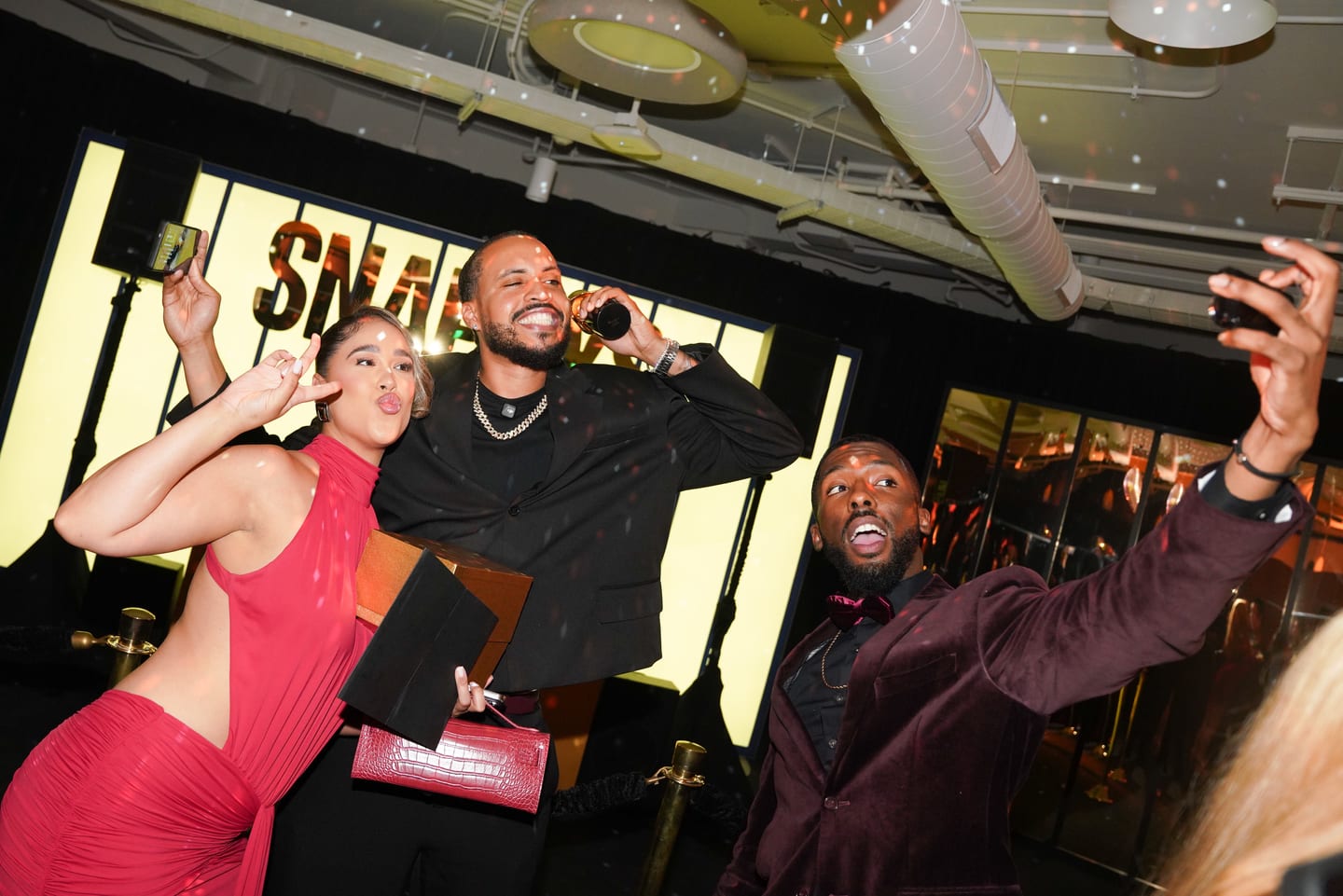 Guests celebrating together, one holding an award certificate