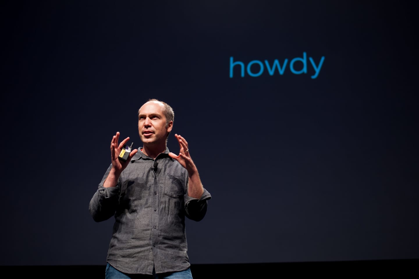 Founder presenting on a dark main stage at a technology conference