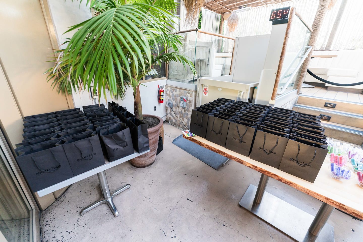 Black gift bags staged on benches beside a large planter on the rooftop at the TikTok and Ulta Beauty #TikTokBeauty dinner on the LouLou rooftop in Santa Monica