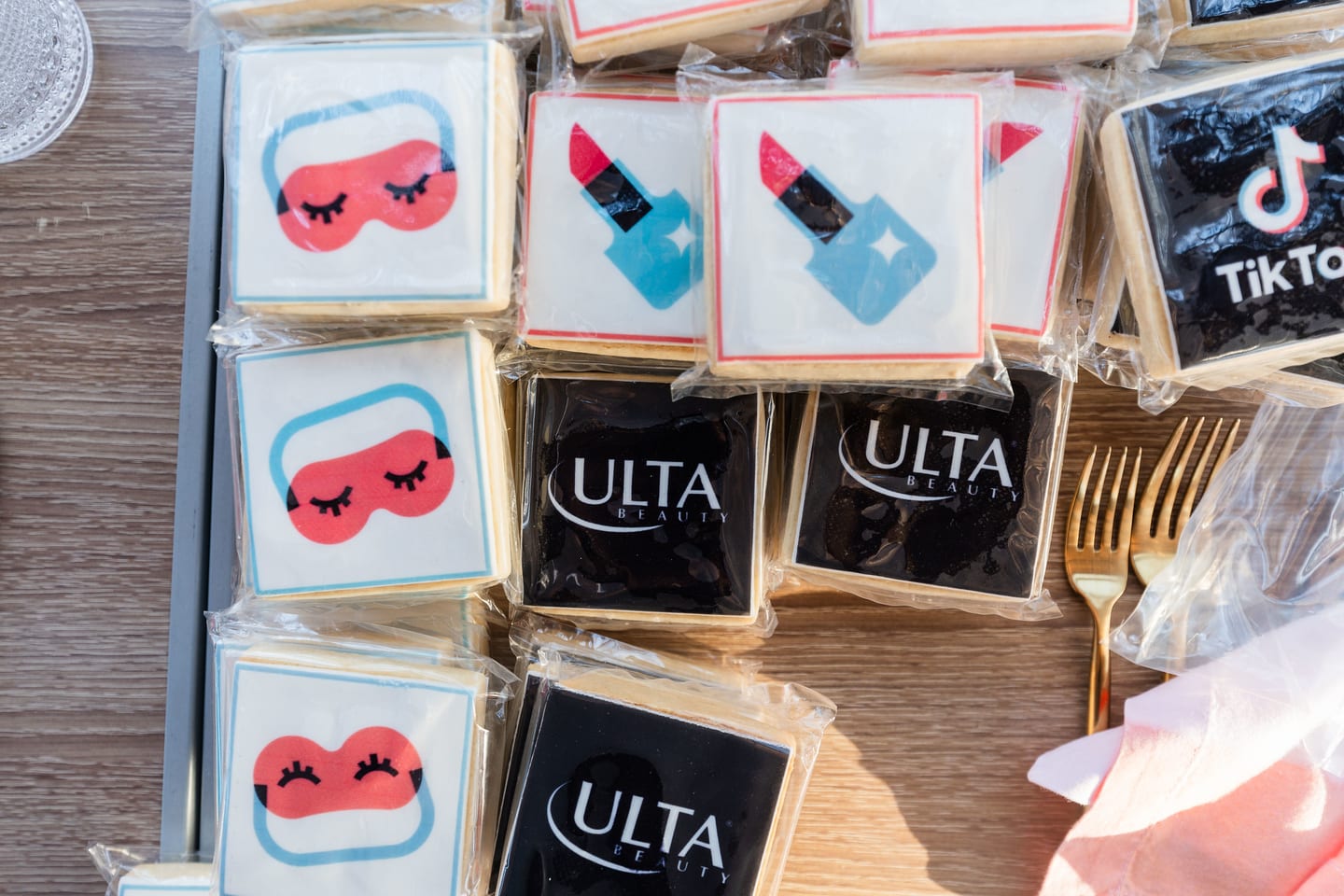 Iced cookies decorated as eye masks, lipsticks and nail polish alongside black cookies printed with the Ulta Beauty and TikTok logos at the TikTok and Ulta Beauty #TikTokBeauty dinner on the LouLou rooftop in Santa Monica