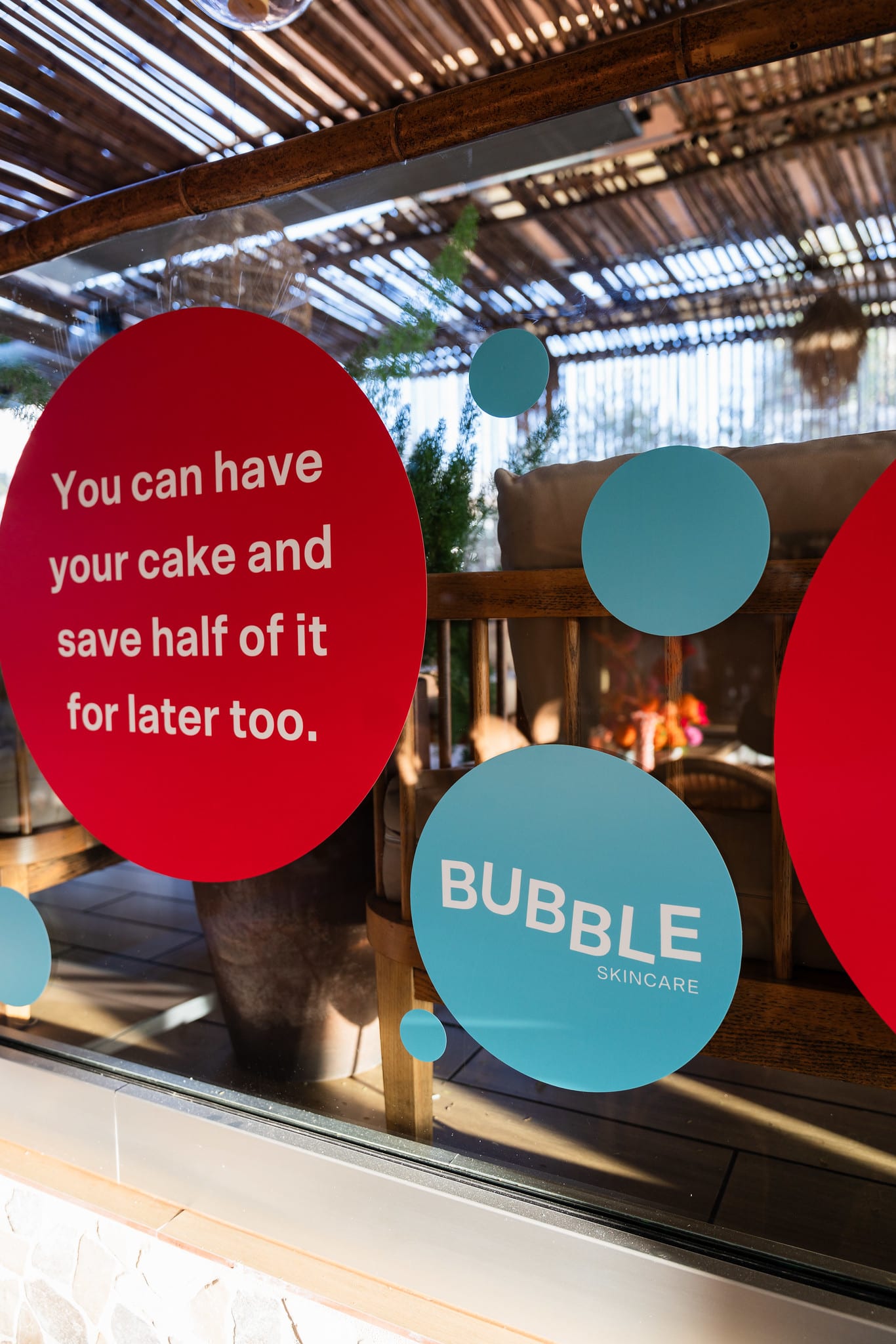 A rooftop window decal reading you can have your cake and save half of it for later too, with Bubble Skincare circles at the TikTok and Ulta Beauty #TikTokBeauty dinner on the LouLou rooftop in Santa Monica