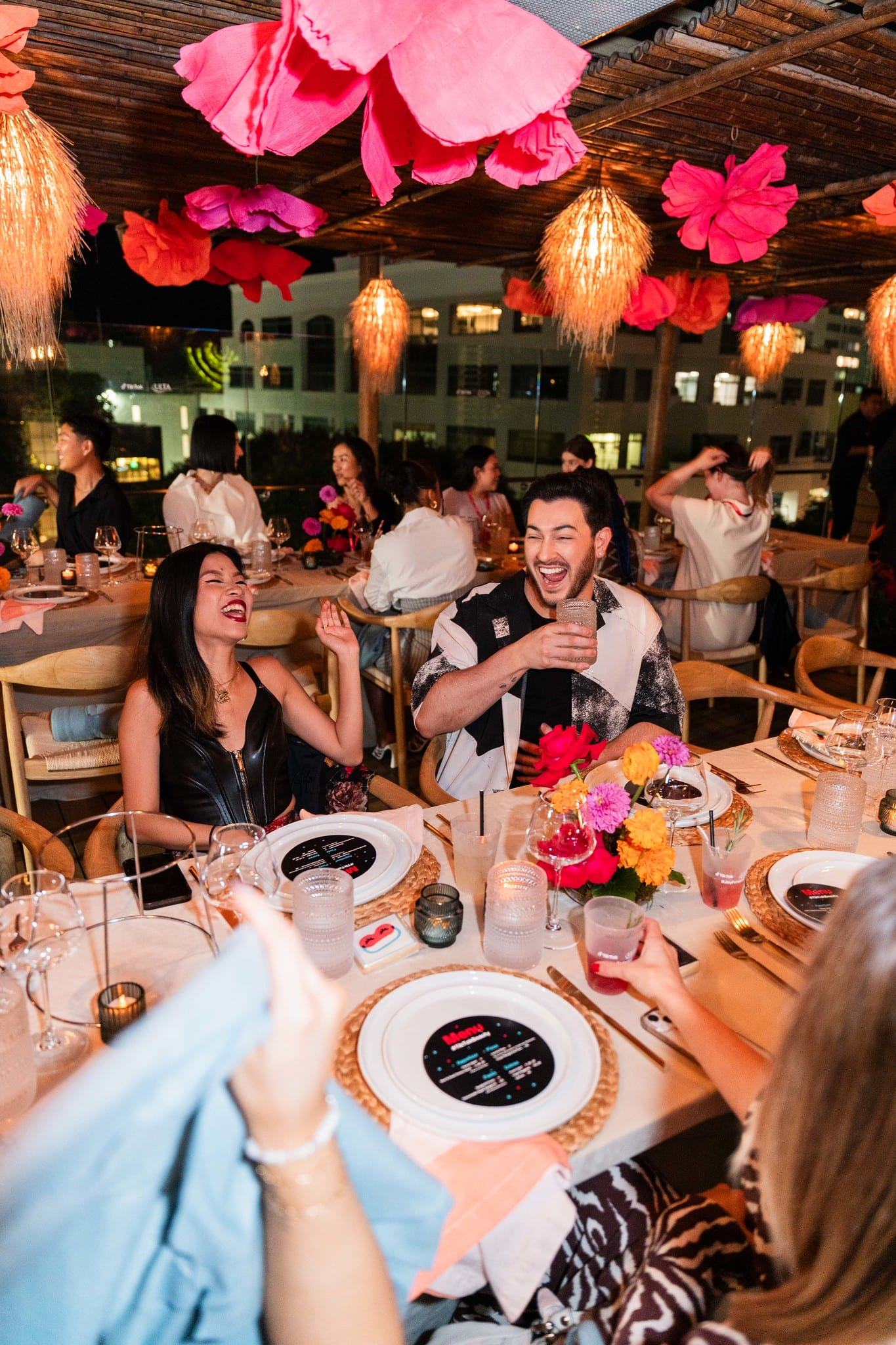 Guests at the dinner table with phones out, filming the evening at the TikTok and Ulta Beauty #TikTokBeauty dinner on the LouLou rooftop in Santa Monica