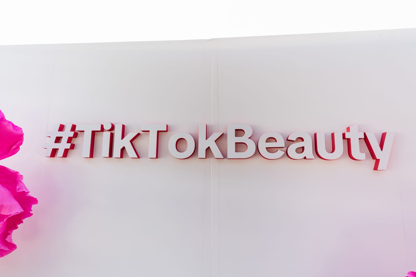 Dimensional pink #TikTokBeauty lettering mounted on a white wall at the TikTok and Ulta Beauty #TikTokBeauty dinner on the LouLou rooftop in Santa Monica