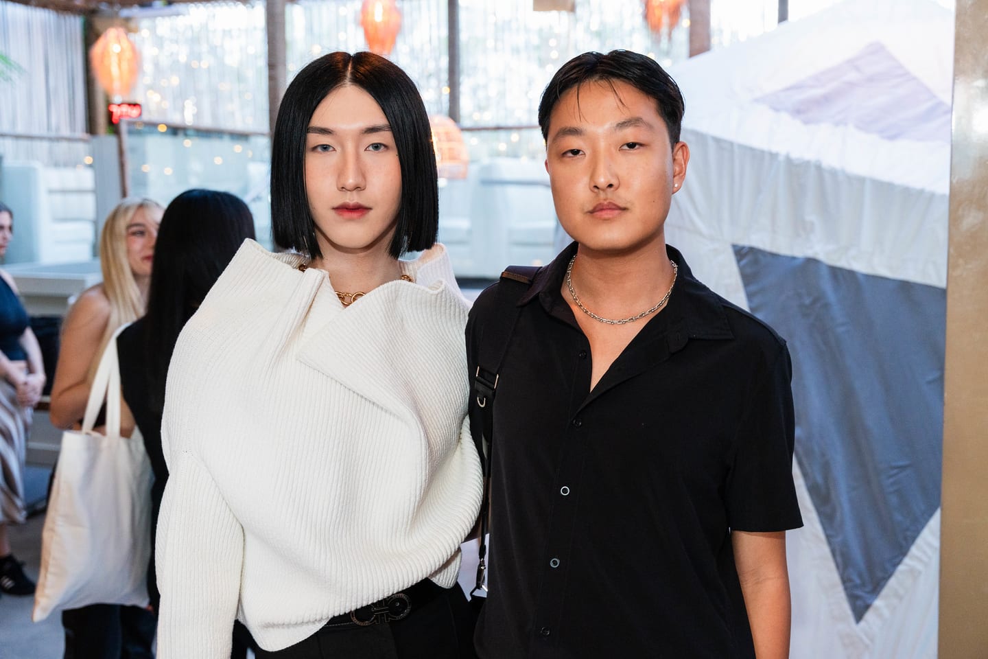 Two guests in white and black posing together on the rooftop at the TikTok and Ulta Beauty #TikTokBeauty dinner on the LouLou rooftop in Santa Monica