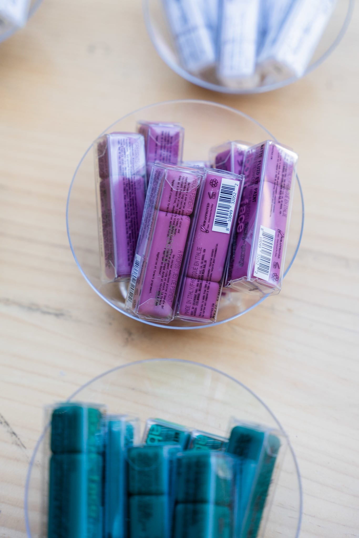 Purple and teal product sample tubes arranged in a glass dish at a beauty brand station at the TikTok and Ulta Beauty #TikTokBeauty dinner on the LouLou rooftop in Santa Monica