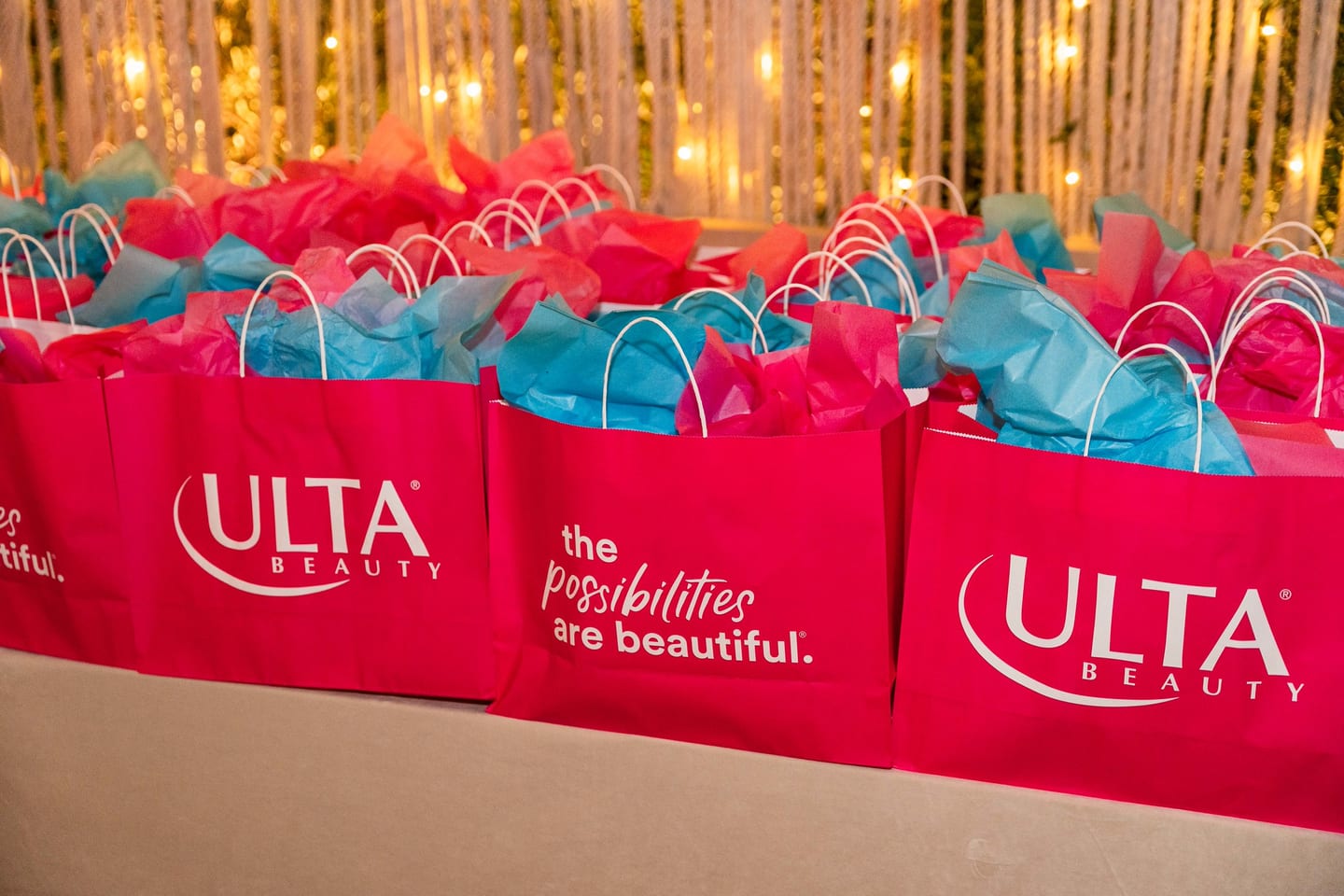 Rows of pink Ulta Beauty gift bags printed with the possibilities are beautiful at the TikTok and Ulta Beauty #TikTokBeauty dinner on the LouLou rooftop in Santa Monica