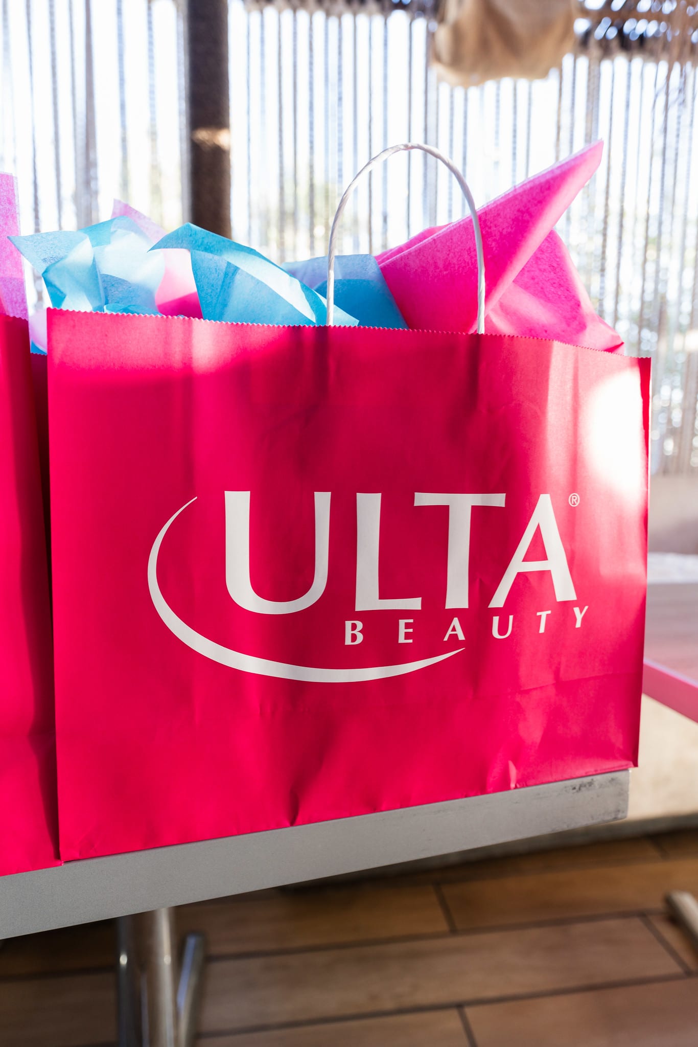 A close view of a pink Ulta Beauty tote bag with blue tissue at the TikTok and Ulta Beauty #TikTokBeauty dinner on the LouLou rooftop in Santa Monica