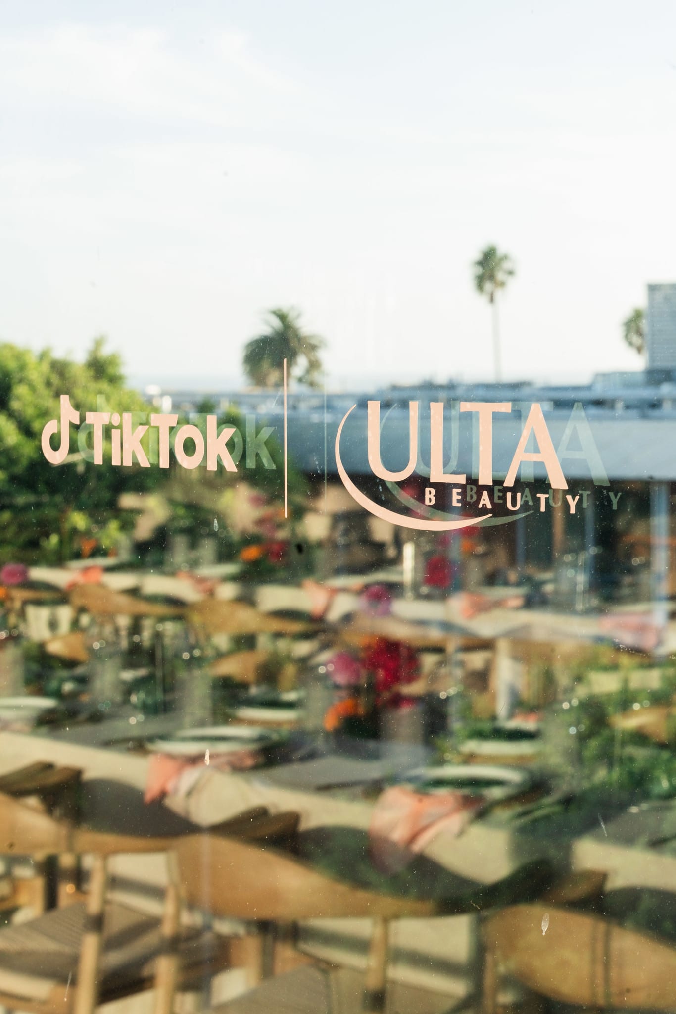 TikTok and Ulta Beauty window branding above a floral brand activation space in Santa Monica
