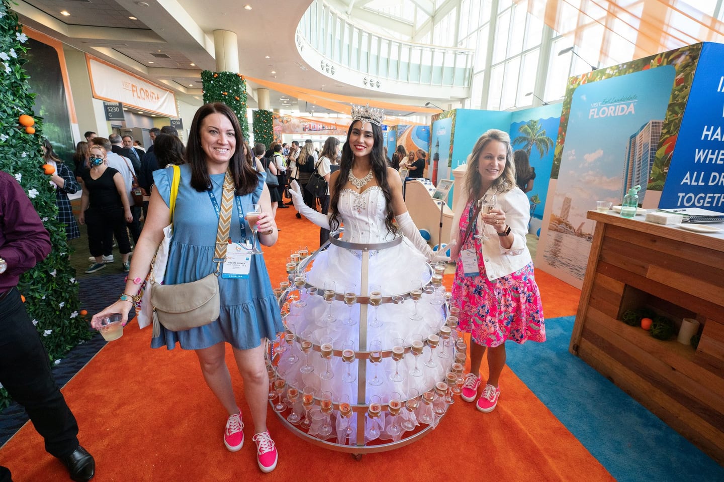 Attendees with exhibitor badges on the show floor at the IPW travel trade show